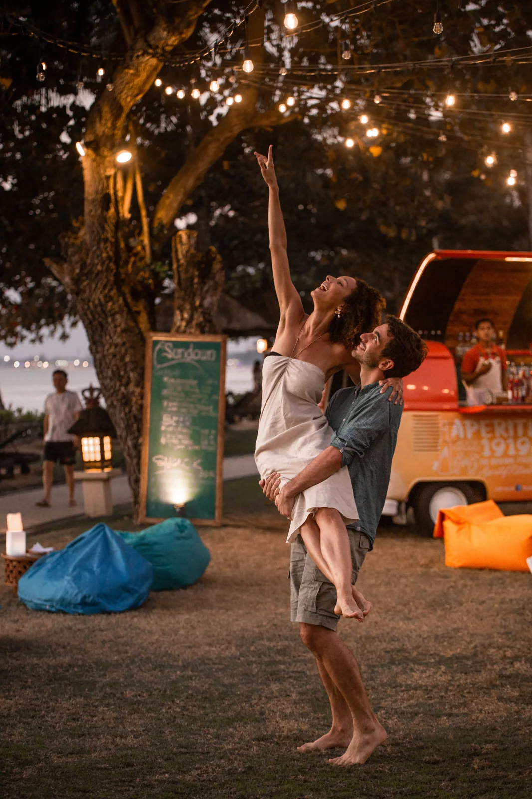 A couple celebrating together beneath evening lights in Bali