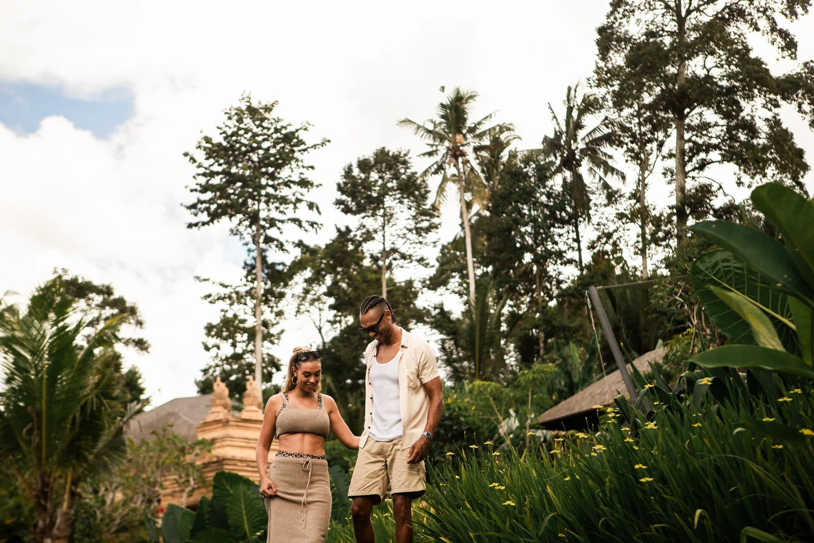 A couple walking together through a tropical Bali garden