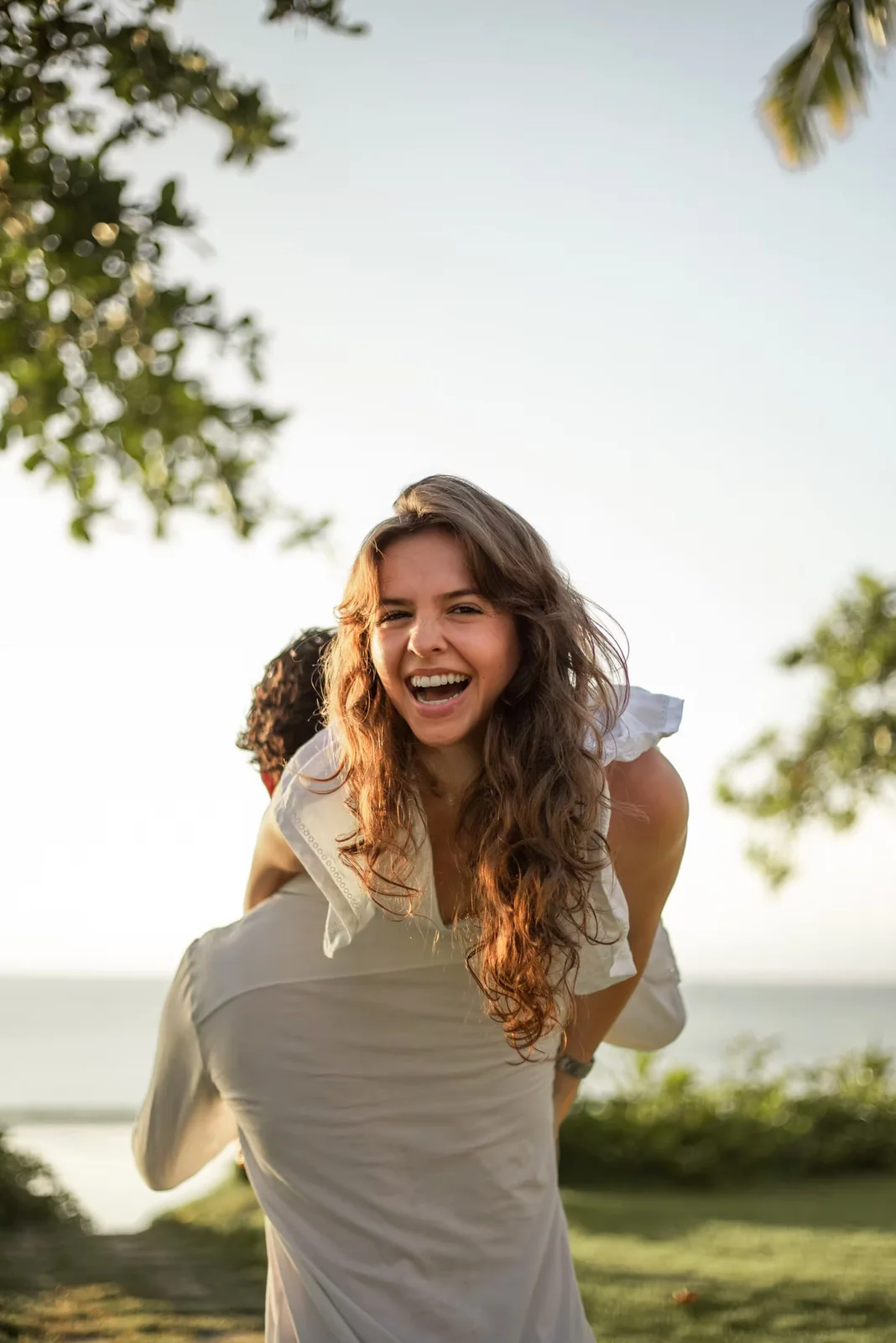 A laughing couple enjoying their honeymoon portrait session in Bali