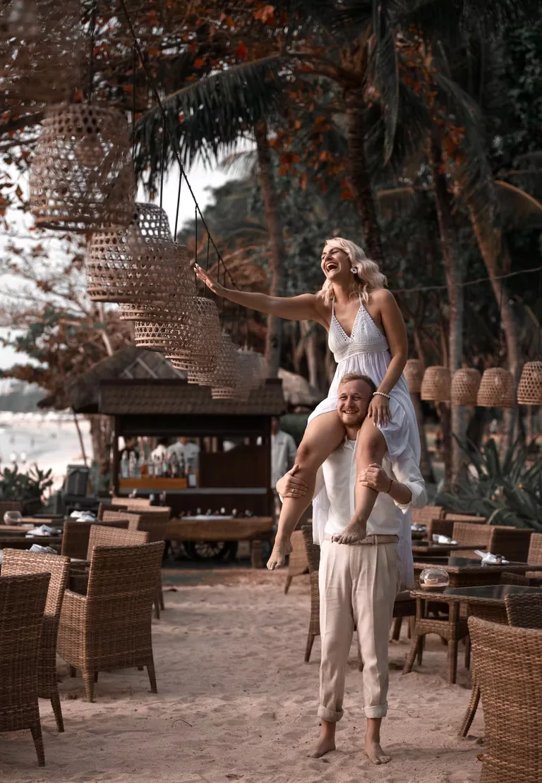 A couple laughing together on a Bali beach