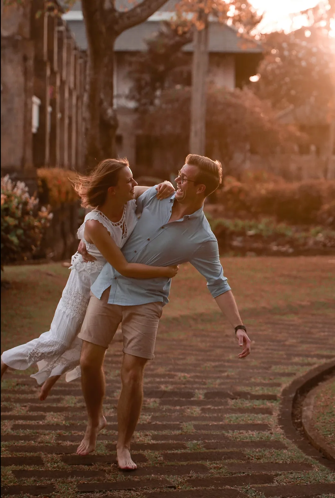 A couple laughing together in warm Bali sunset light